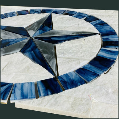 Blue, Gray, and White Glass Texas Star wall medallion with ledger stone background.