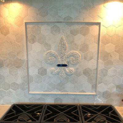 Post installation picture of Mosaic Stone Fleur de Lis with Marble and Custom Blue Glass Accent Piece.  Backsplash medallion / tile insert.